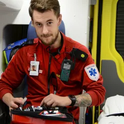 Ambulansearbeider i ambulansebil