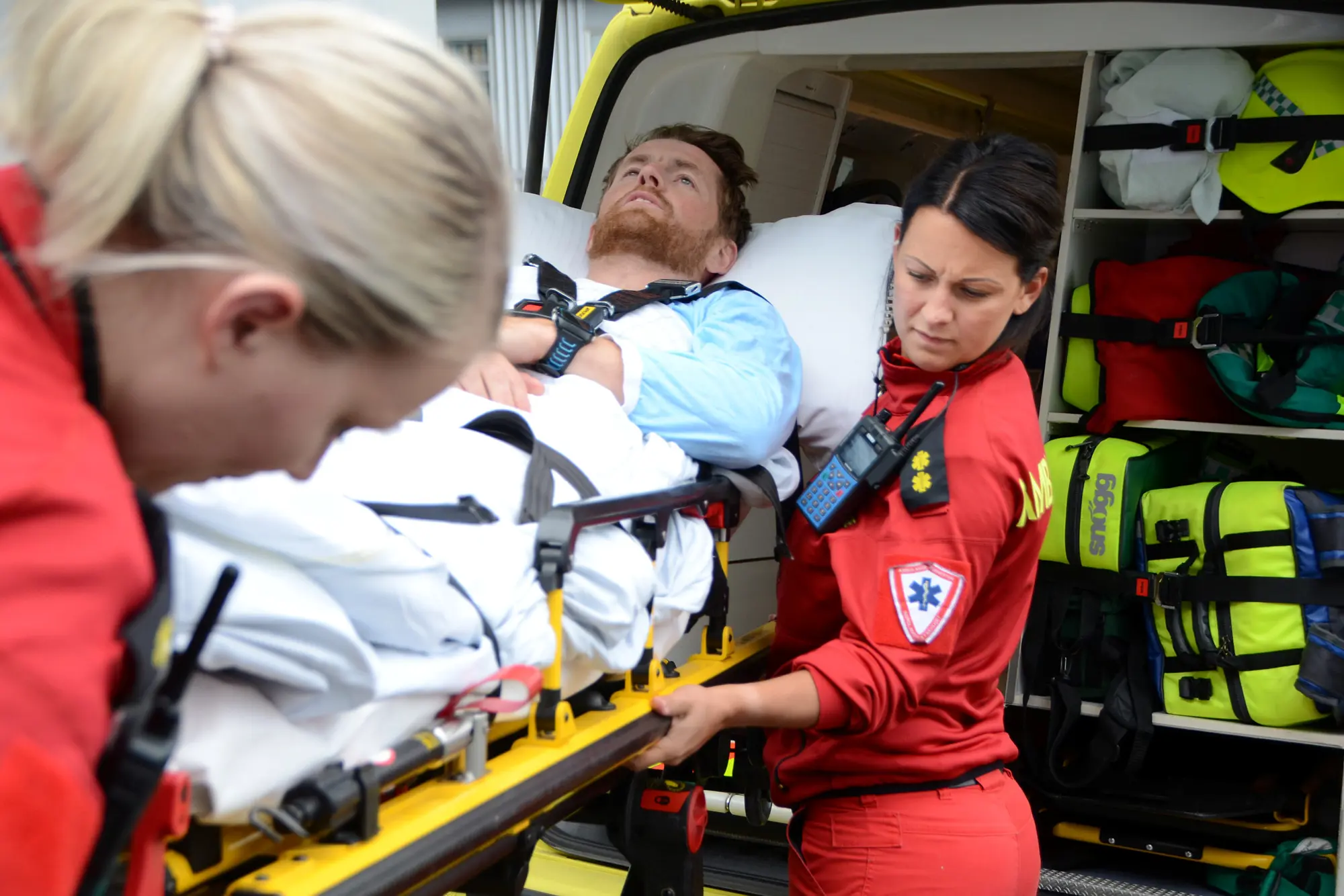 To ambulansearbeidere og pasient på båre